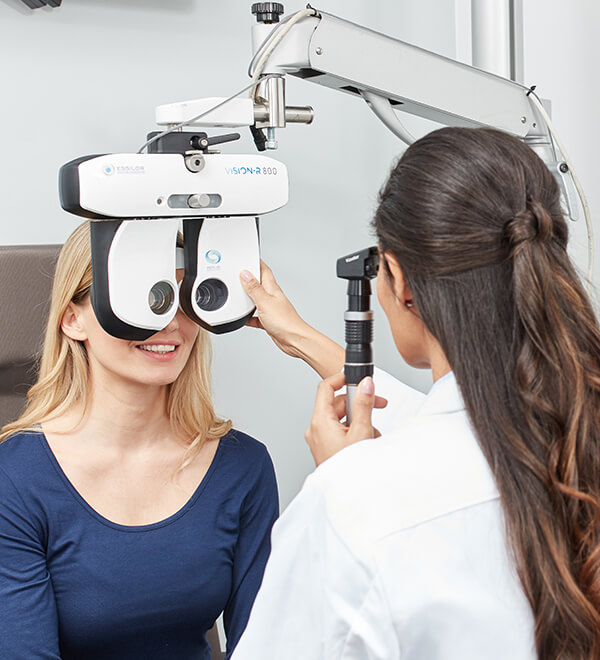Optician using an ophthalmoscope on a customer