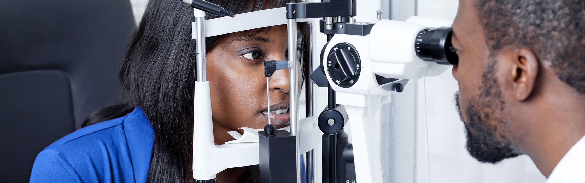 Young woman having an eye test with male optician